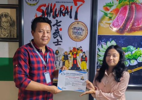 Anjit Lama awarding an Easy Learners certificate to a student